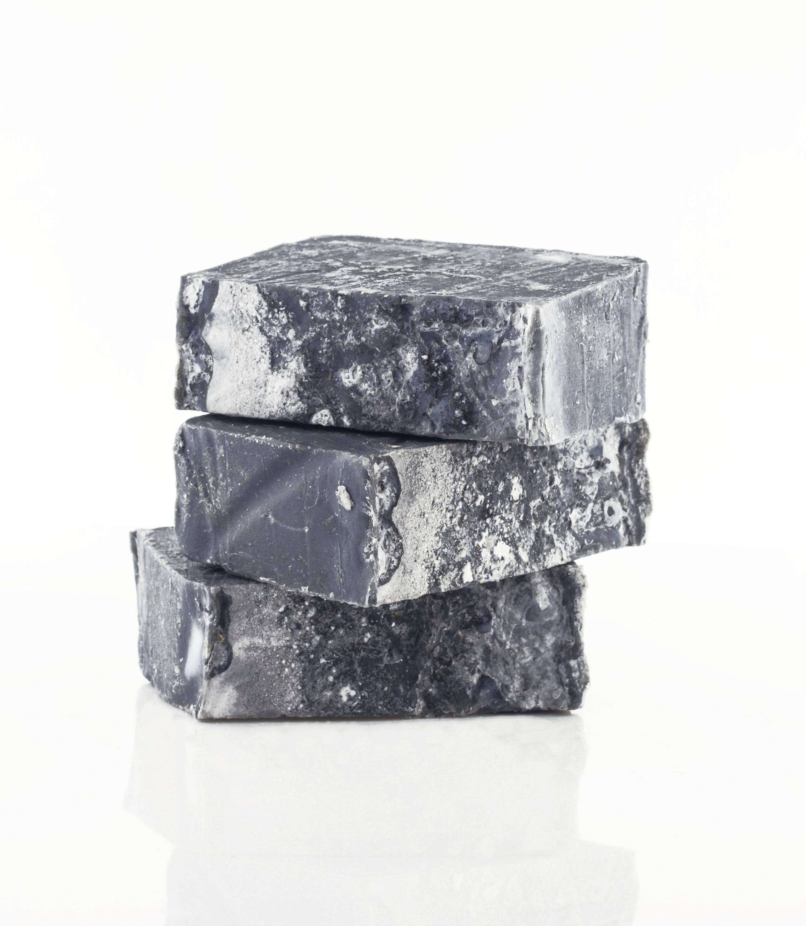 Charcoal Tea Tree Handcrafted Soap with a rich, dark color, designed for deep cleansing and detoxifying skin